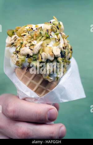 Pistachio rolled ice-cream at Bakdash inside Souk al-Hamidiyeh in the Old Town of Damascus, Syria. This ice-cream shop is an institution in Damascus. Stock Photo