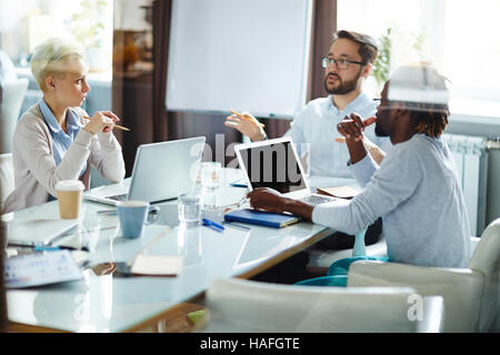 Business team brainstorming during discussion of plans Stock Photo