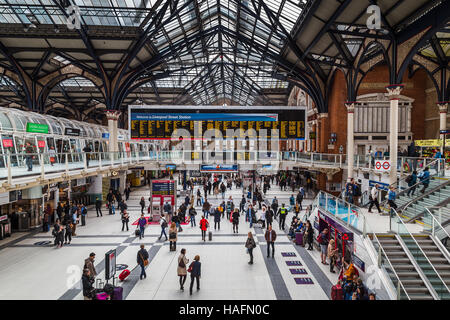 Locals & tourists pass across the busy concourse at Liverpool Street train station in London one morning. Stock Photo