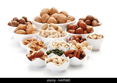 Assorted nuts and kernels in ceramic bowls, pecans, walnuts, hazelnuts, macadamia nuts, peanuts, almonds, pistachios Stock Photo