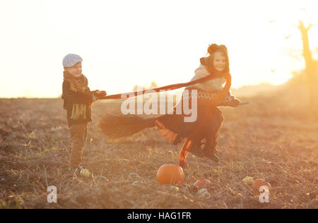 Children playing together. Halloween. girl flies on a broomstick. witch. Stock Photo