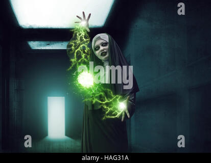 Scary devil nun for halloween concept image. She is casting satanic spell Stock Photo