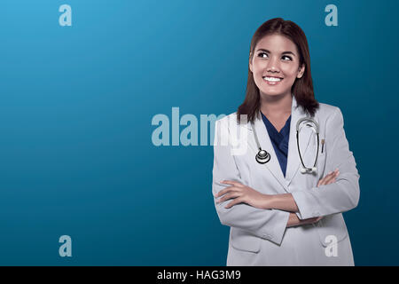 Portrait of a smiling female doctor over blue background Stock Photo