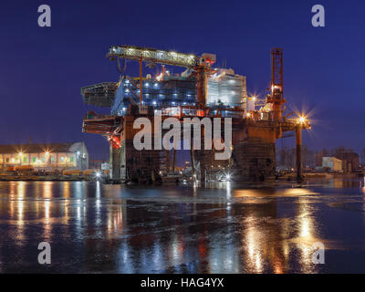 Oil rig under construction at night in Gdansk, Poland. Stock Photo