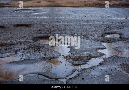 there are many potholes on the roadway Stock Photo