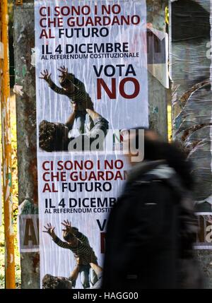 Rome, Italy. 1st Dec, 2016. Two people walk past a poster in support of the 'No' vote, reading 'There are some No concerning the future', in an upcoming constitutional referendum in Rome, Italy, Dec. 1, 2016. On Dec. 4, voters will be called to have their say on a constitutional reform package, which the parliament had already approved with six consecutive readings in over two and a half years long debate. Credit:  Jin Yu/Xinhua/Alamy Live News Stock Photo