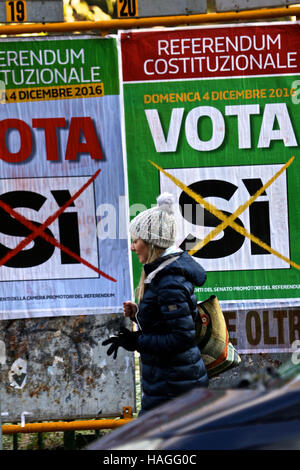 Rome, Italy. 1st Dec, 2016. A woman walks past a poster in support of the 'Yes' vote in an upcoming constitutional referendum in Rome, Italy, Dec. 1, 2016. On Dec. 4, voters will be called to have their say on a constitutional reform package, which the parliament had already approved with six consecutive readings in over two and a half years long debate. Credit:  Jin Yu/Xinhua/Alamy Live News Stock Photo