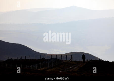 A lone hill walker walking along Offas Dyke Path in the Clwydian Range in Denbighshire, North Wales. Stock Photo