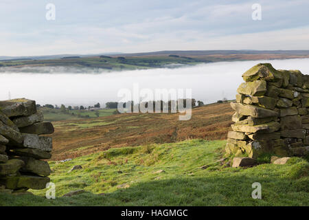 The view from Barcombe Hill, home of an Iron Age hill-fort and the Long Stone, with low-lying mist clinging to the South Tyne valley beyond Stock Photo