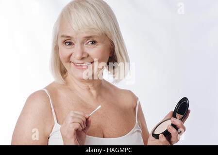 Cheerful pleasant woman holding a mirror Stock Photo