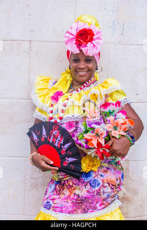 Cuban woman with traditional clothing in old Havana street. The historic center of Havana is UNESCO World Heritage Site since 1982. Stock Photo