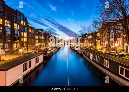 Canal with House Boats in Amsterdam Netherlands Stock Photo