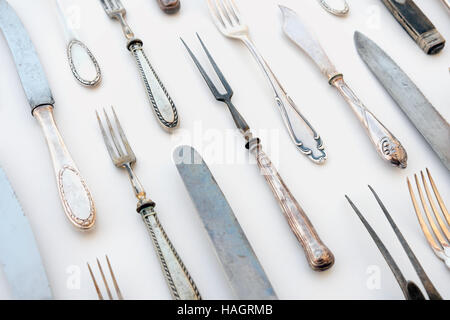 group of vintage cutlery / flatware decorated on white table cloth - restaurant table concept Stock Photo