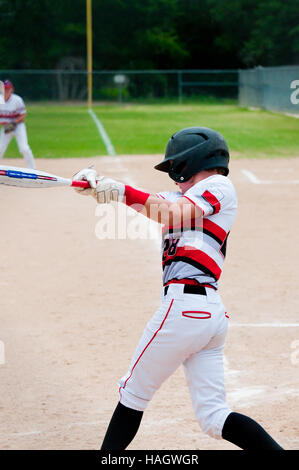 American teenage baseball player with big swing. Stock Photo