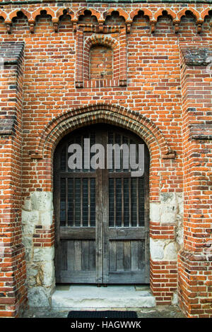 Double wooden door in red brick extension at church Stock Photo