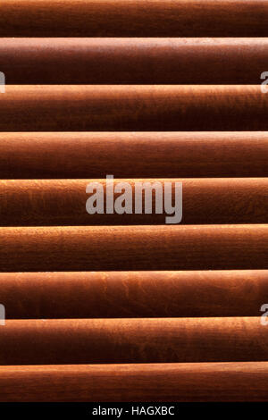 Sunlight showing through wooden blinds on a lounge window Stock Photo