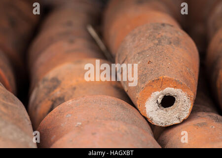 A stack of used clay pots in the garden Stock Photo