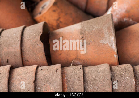 A stack of used clay pots in the garden Stock Photo