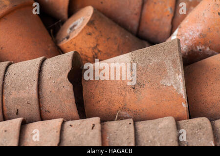 A stack of used clay pots in the garden Stock Photo