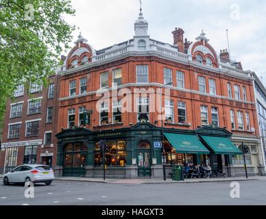 People enjoy a meal at the Peasant Gastropub in Clerkenwell, London ...