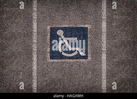 wheelchair parking symbol on asphalt car park Stock Photo