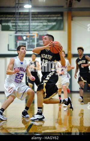 Player finishing off a baseline drive toward the basket during a high school basketball game. USA. Stock Photo