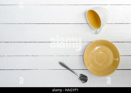 Empty Cup, saucer and spoon on wooden background,top view. Stock Photo
