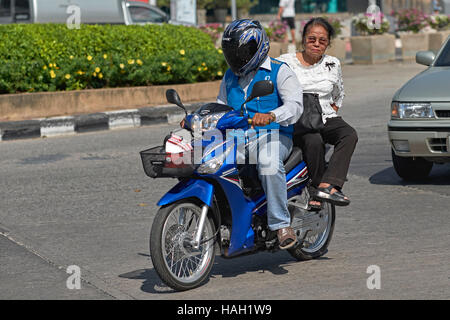 Thailand motorcycle taxi driver transporting elderly woman customer. Thailand S. E. Asia Stock Photo