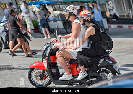 Young couple on a motorcycle. Thailand is the 3rd most dangerous country for road fatalities, mainly motorcycles. S. E. Asia Stock Photo
