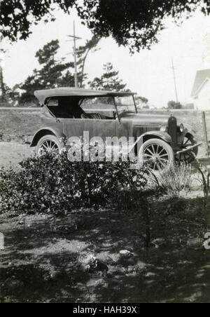 Antique c1920 photograph, roadster automobile in driveway. SOURCE: ORIGINAL PHOTOGRAPHIC PRINT. Stock Photo