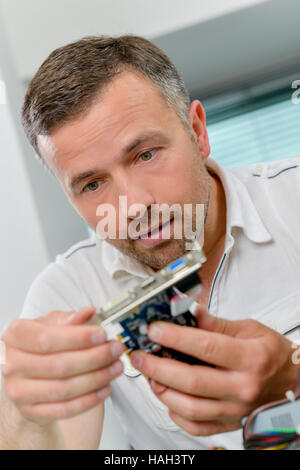 Man repairing a video card Stock Photo