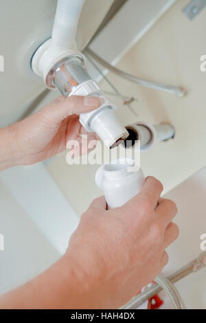 Fixing a sink Stock Photo