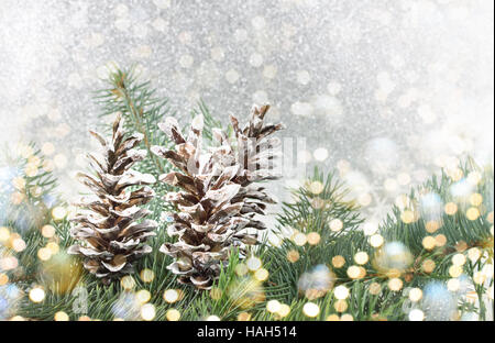 Pinecones and fir tree on sparkling background. Christmas decoration background Stock Photo