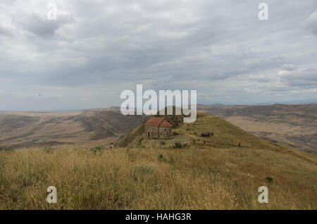Small chapel on the top of a hill near David Gareja Monastery , at background view on the semi-desert and steppe slopes of Gareja Mountain,  Georgia Stock Photo