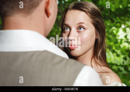 Bride looking at groom with love and tender, selective focus Stock Photo