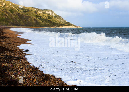 Look east along the shingle beach towards Burning Cliff at Ringstead Bay, Dorset, England, UK Stock Photo
