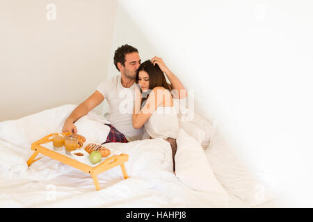 Young couple having a breakfast in the bed Stock Photo