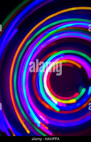 Christmas tree lights spun around to achieve a spiral glowing effect; abstract circular color trails, defocused, abstract Stock Photo