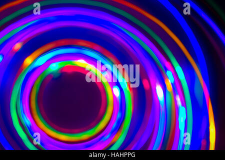 Christmas tree lights spun around to achieve a spiral glowing effect; abstract circular color trails, defocused, abstract Stock Photo