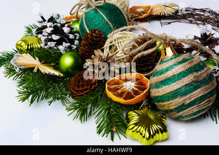 Christmas arrangement with rustic ornaments and dried orange slices. Christmas holidays decoration with fir branches. Stock Photo
