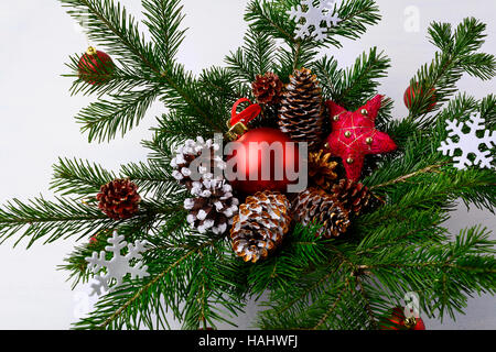 Christmas table centerpiece with golden decorated pine cones and snowflakes. Christmas rustic decoration. Stock Photo