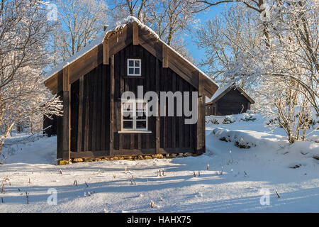 Old wooden cottage in winter landscape Stock Photo