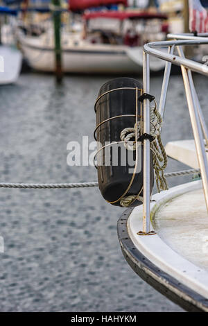 Black boat fender on side of boat Stock Photo