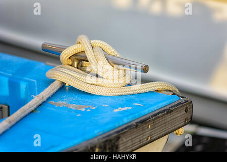 Mooring rope tied to stainless steel cleat Stock Photo