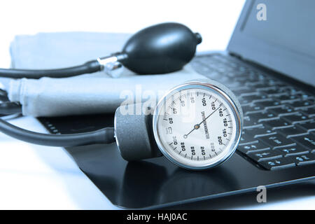 Blood pressure instrument on a computer keyboard Stock Photo