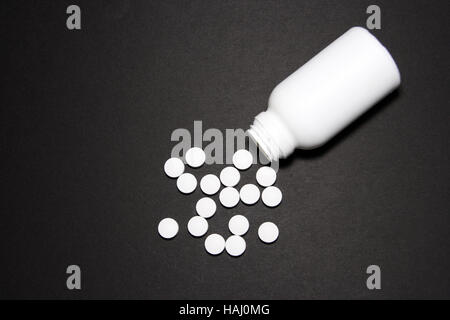 white pills on black background