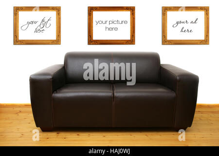 Brown leather sofa and blank photo frames on the wall Stock Photo