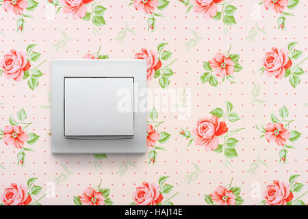 light switch on retro floral wallpaper Stock Photo