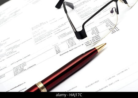 pen and glasses on financial report Stock Photo