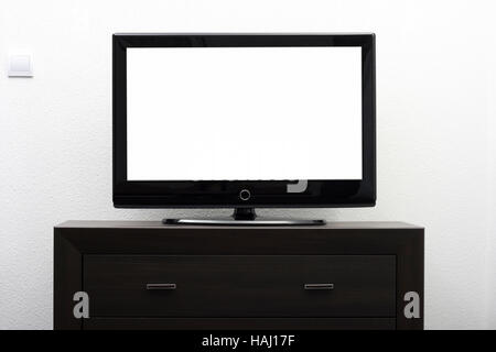 blank tv screen on brown commode against white wall Stock Photo